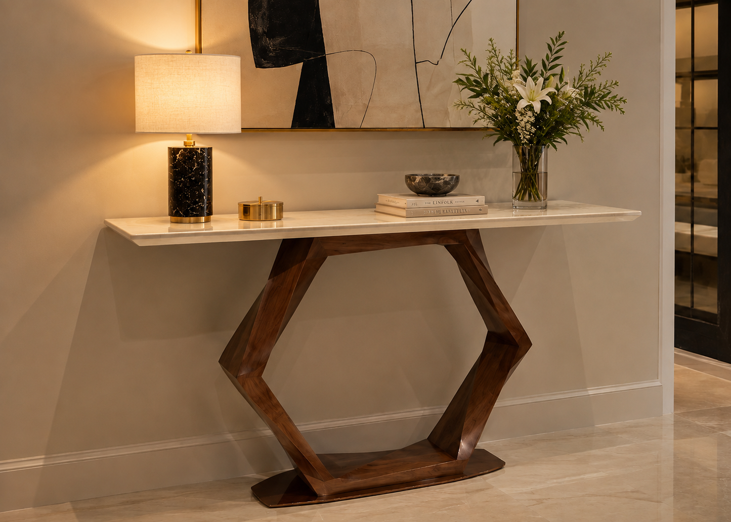 A modern hexagonal console table with a white marble top and dark brown wooden base, styled in a home entryway with a lamp, books, and a vase of flowers.