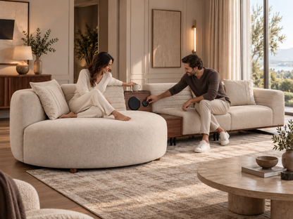 Helen Sofa showing the integrated music system and walnut centre console in use with a coffee cup in a warm luxury interior