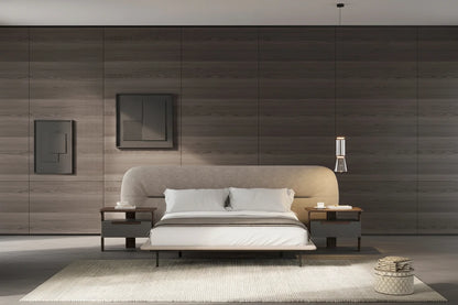 Modern bedroom with a bed, side tables, and a wall-mounted lamp.