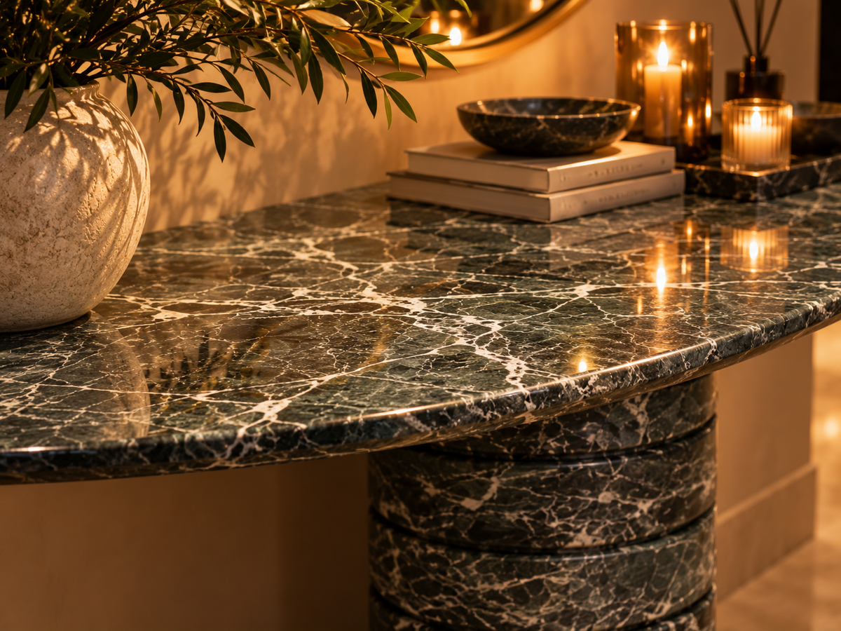 Close-up Verde Strata polished green marble console surface highlighting flowing white stone veining and rounded edge