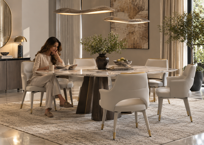 Mira Dining Chair in a luxury dining room with a woman reading