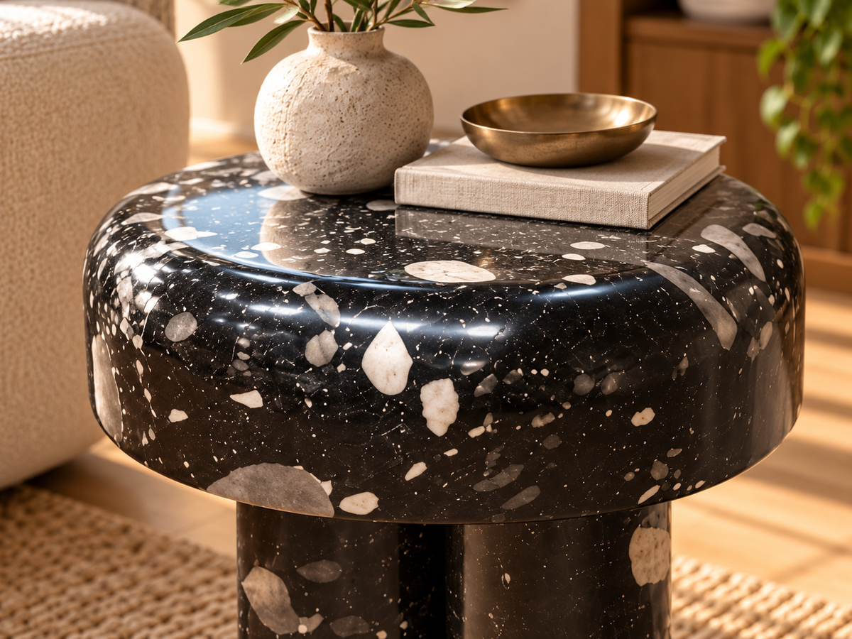 Close-up Noctis glossy black mineral-pattern side table with white and grey terrazzo flecks