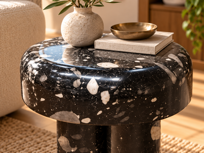 Close-up Noctis glossy black mineral-pattern side table with white and grey terrazzo flecks
