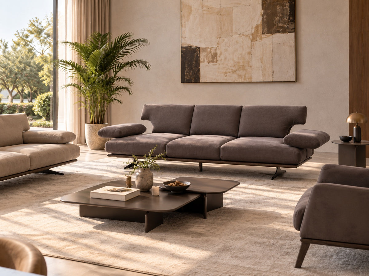 Rapid Sofa three-seat front view showing generously padded back cushions, wide armrests and slim dark base