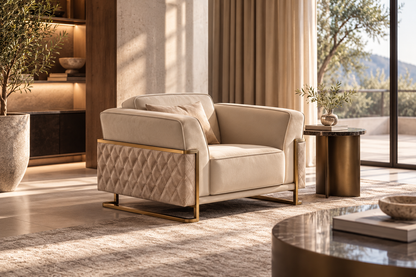 Ravenna Armchair in ivory upholstery with diamond-quilted panels and a gold-tone frame, styled in a luxury reading room