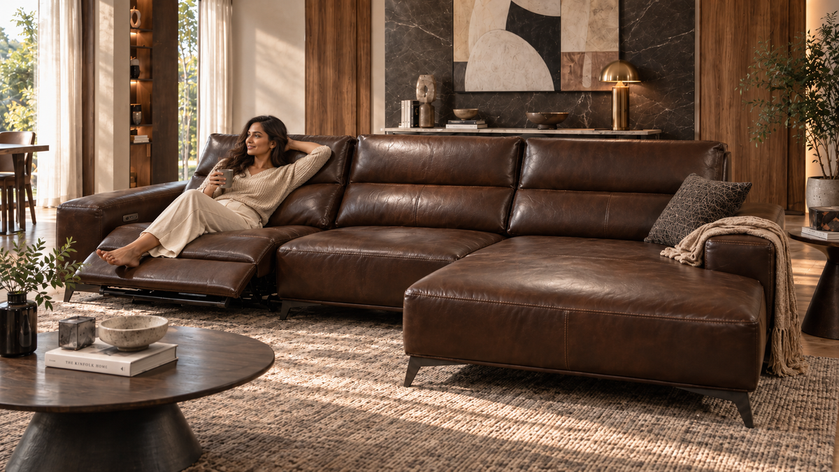 Rovena Leather Lounge Sofa with left recliner extended and modern Indian woman relaxing