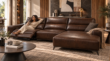 Rovena Leather Lounge Sofa with left recliner extended and modern Indian woman relaxing
