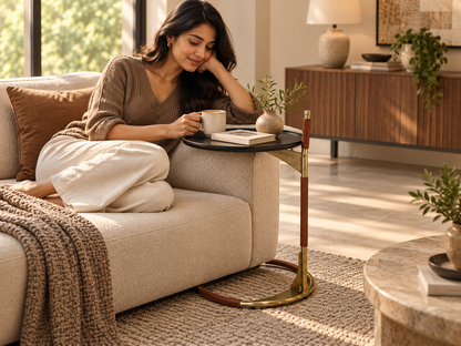 Woman enjoying coffee beside Savio C-shaped peg table tucked neatly against her sofa