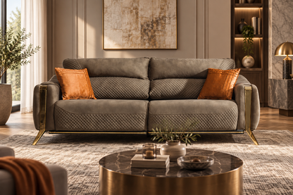 Taj Sofa in olive taupe upholstery with quilted detailing and gold metal accents in a luxury living room