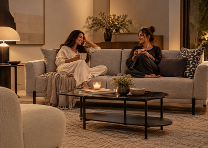 Terra Sofa by Enza Home in a warm evening living room with two friends relaxing together