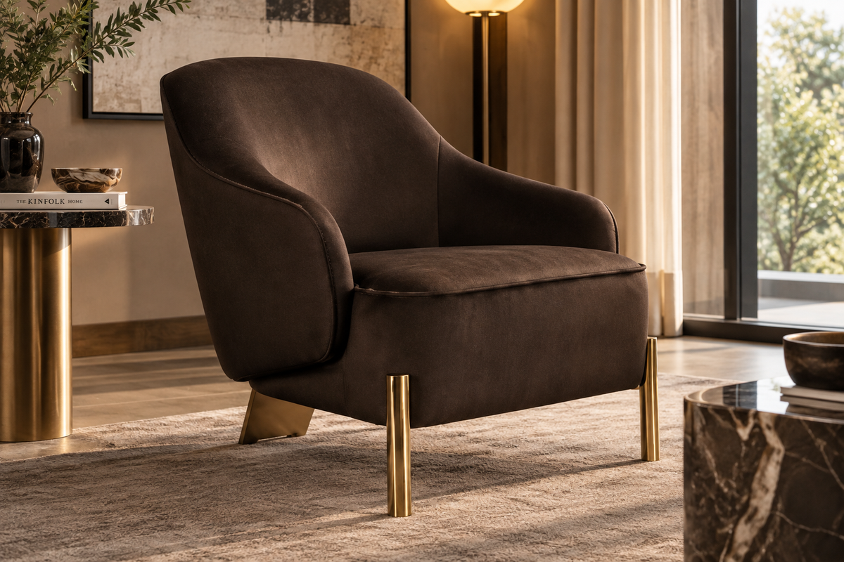 Varello Armchair in dark chocolate upholstery with curved wraparound back and brass-tone legs in a warm luxury living room