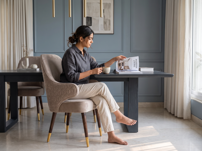 Versace Arm Dining Chair lifestyle with a seated woman reading